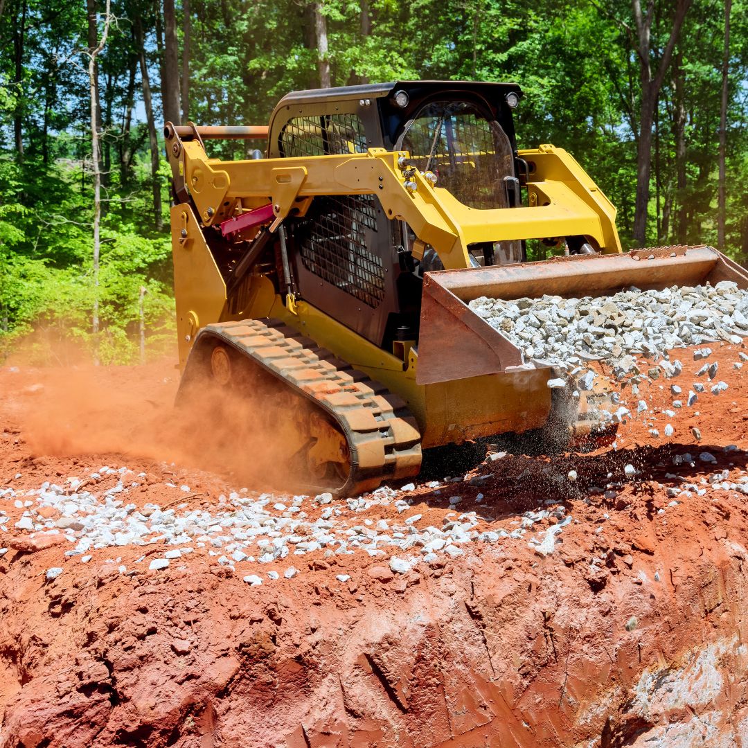 Skid steer stirring up dirt while working